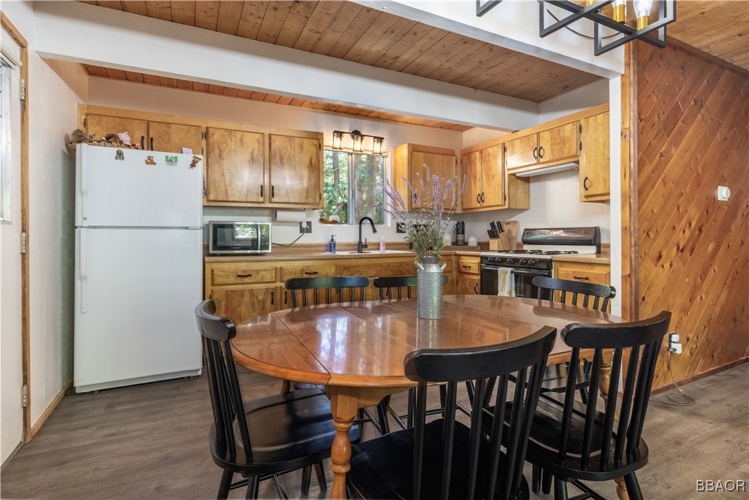 753 Maple Lane Sugarloaf, CA 92386 - Photo 22 of 50 a dining table chairs and a refrigerator