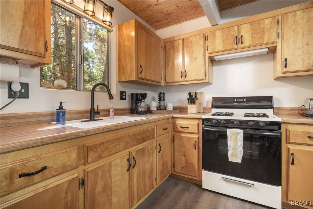 753 Maple Lane Sugarloaf, CA 92386 - Photo 24 of 50 a kitchen with stainless steel appliances granite countertop a sink and a stove next to a window