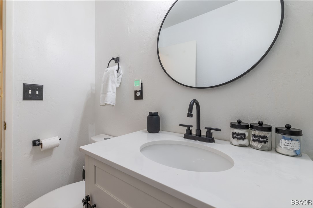 753 Maple Lane Sugarloaf, CA 92386 - Photo 34 of 50 a bathroom with a sink and a mirror