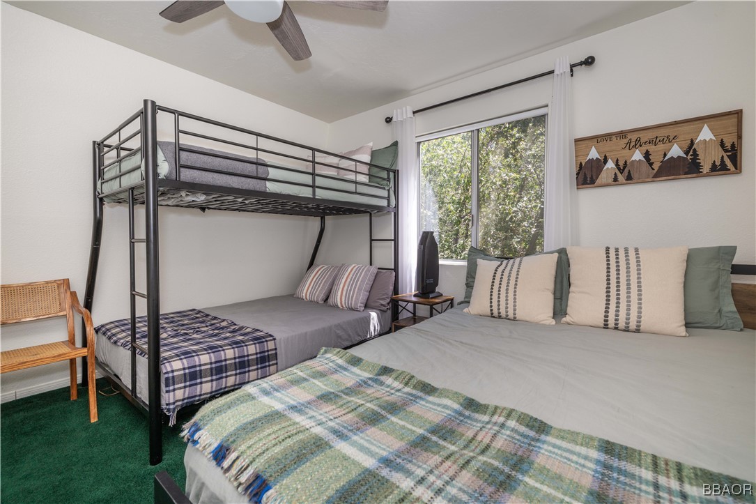 753 Maple Lane Sugarloaf, CA 92386 - Photo 36 of 50 a bedroom with a bed and wooden floor