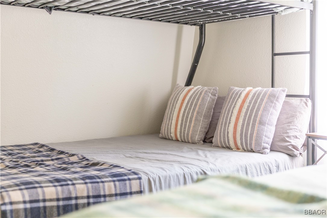 753 Maple Lane Sugarloaf, CA 92386 - Photo 39 of 50 a bedroom with a bed and a mirror