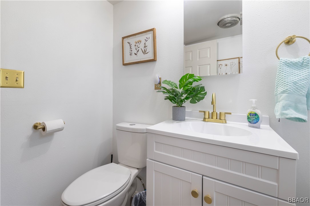 753 Maple Lane Sugarloaf, CA 92386 - Photo 42 of 50 a bathroom with a toilet sink and mirror