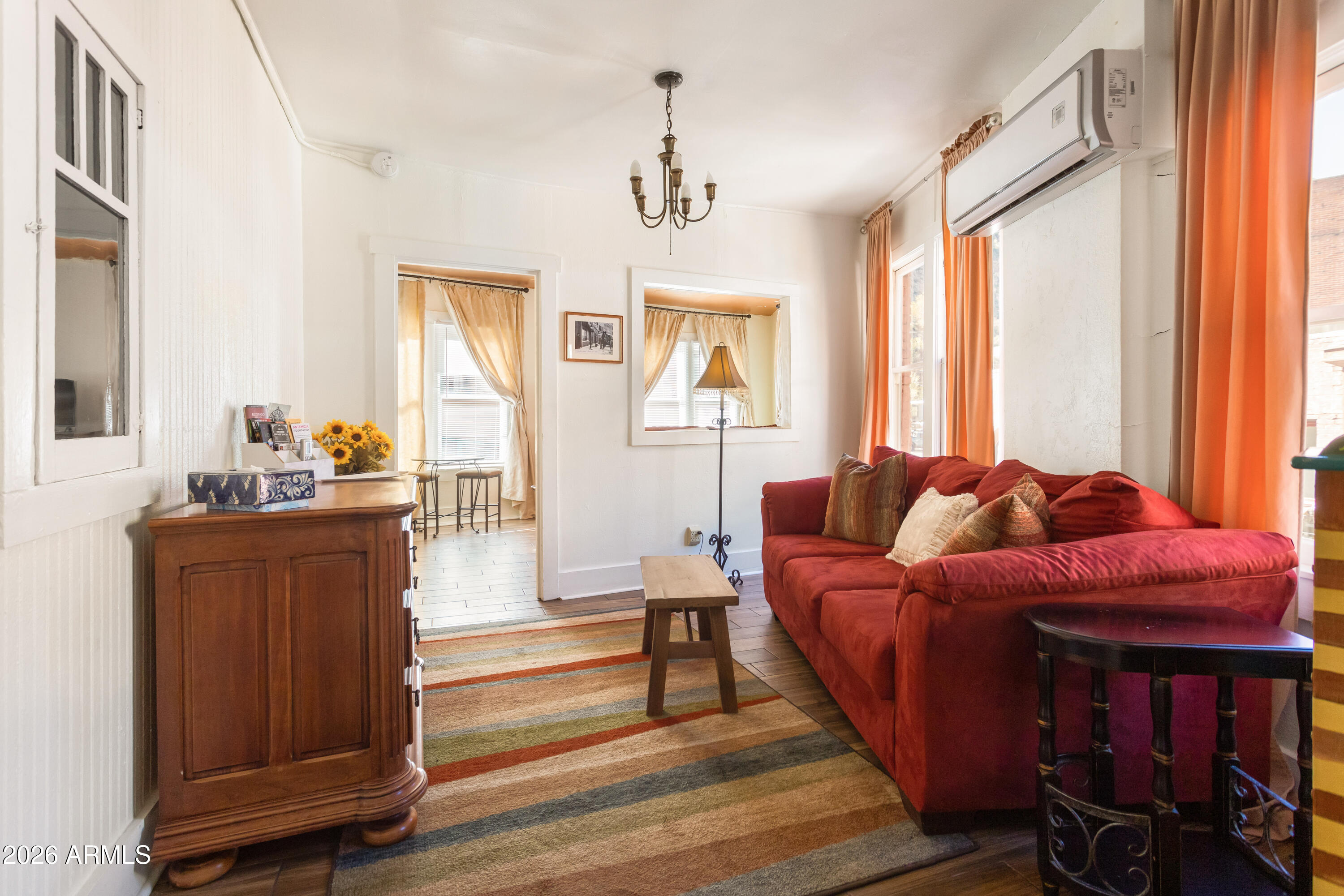 41 Main Street Bisbee, AZ 85603 - Photo 25 of 33 a living room with furniture a window and a chandelier