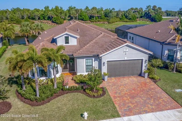 a aerial view of a house with yard and green space