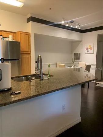 a kitchen with a sink and a refrigerator