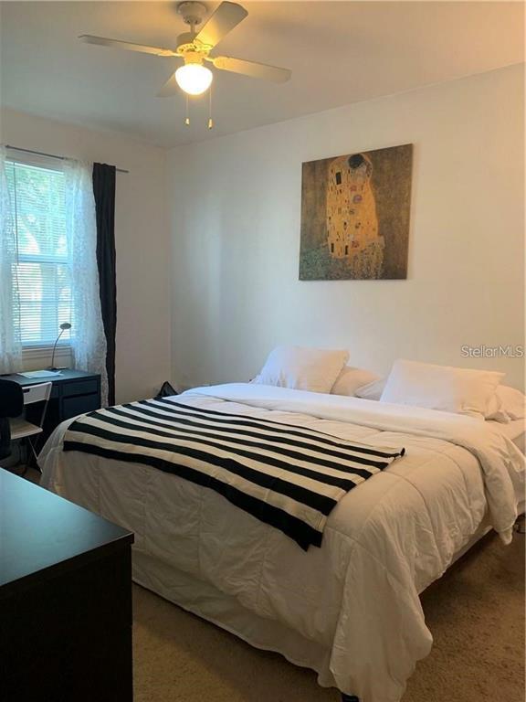 3446 Soho Street, Unit 101 Orlando, FL 32835 - Photo 6 of 9 a bedroom with bed and window