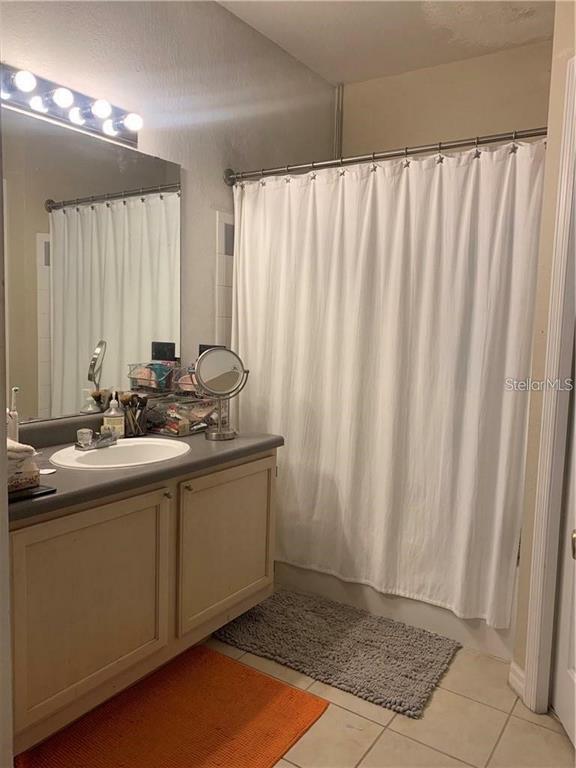 3446 Soho Street, Unit 101 Orlando, FL 32835 - Photo 7 of 9 a kitchen with a sink and cabinets