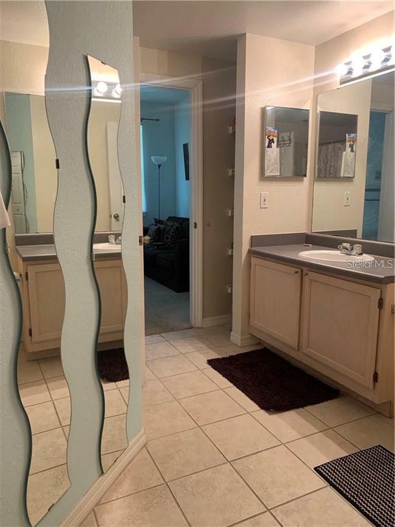 3446 Soho Street, Unit 101 Orlando, FL 32835 - Photo 9 of 9 a room with gym equipment and glass door shower