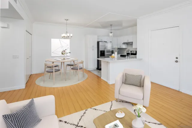 a living room with furniture and a dining table with kitchen view