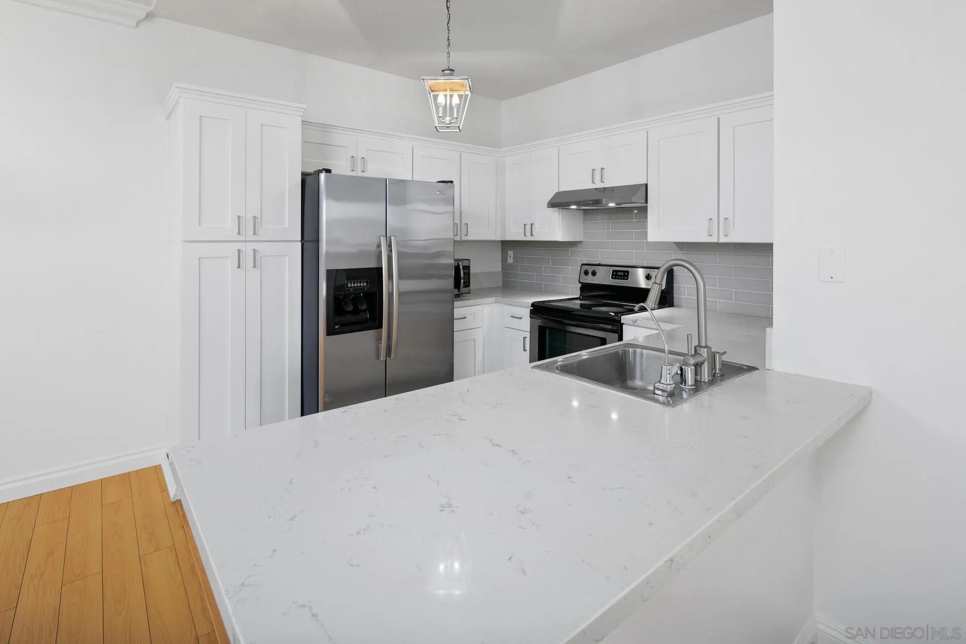 17161 Alva Road, Unit 1211 San Diego, CA 92127 - Photo 3 of 17 a kitchen with stainless steel appliances a refrigerator sink and stove