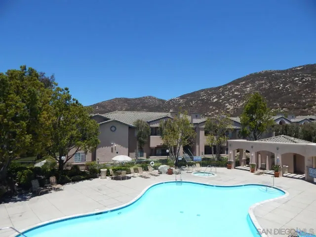 a view of a house with furniture and fire pit