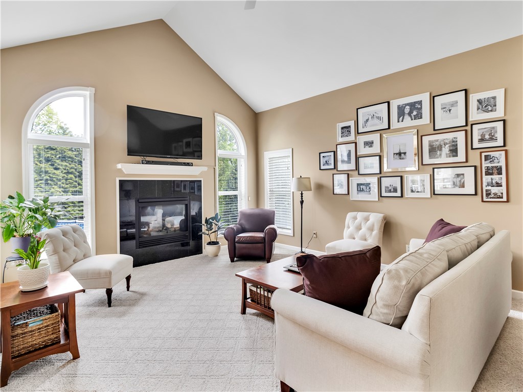 8 Claridge Circle Penfield, NY 14580 - Photo 18 of 47 Great room with volume ceiling and cozy fireplace.