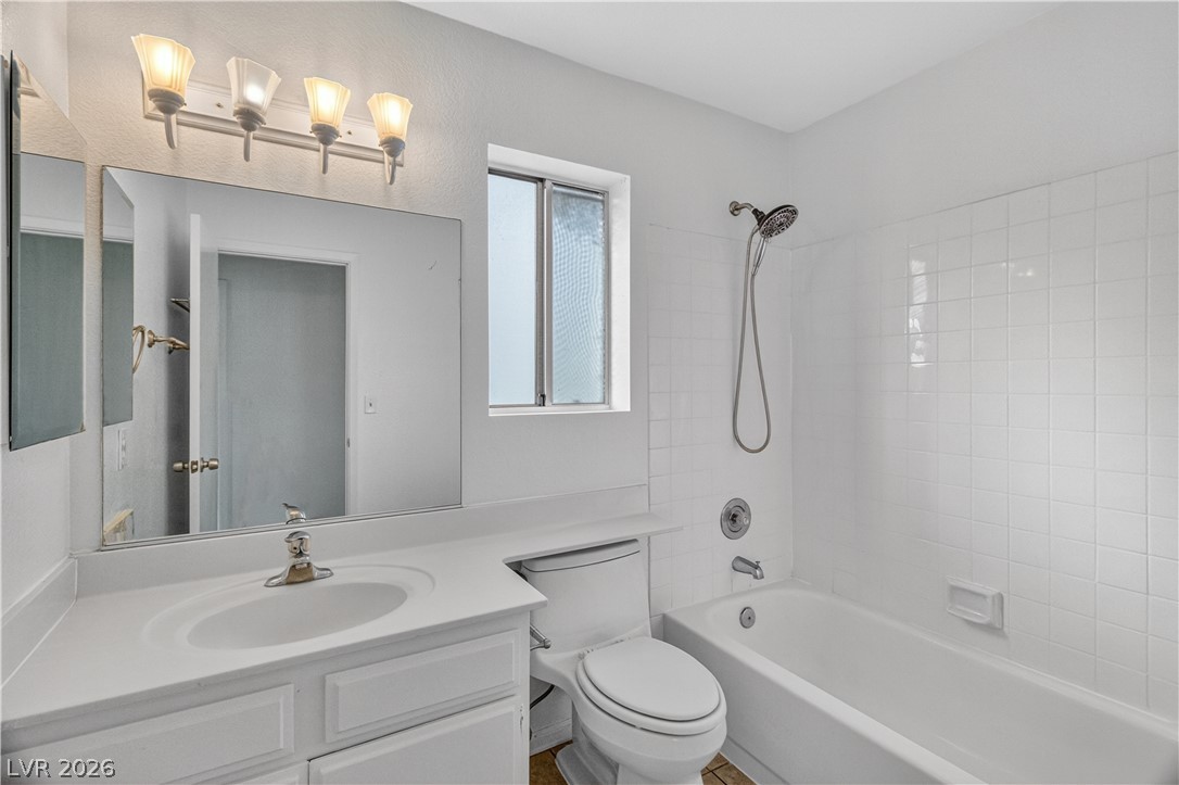 3156 Terrace View Drive Laughlin, NV 89029 - Photo 42 of 94 White tile shower and vanity with window provides essential bathroom comforts.