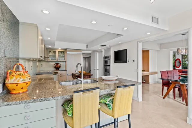 a kitchen with stainless steel appliances granite countertop a stove and white cabinets