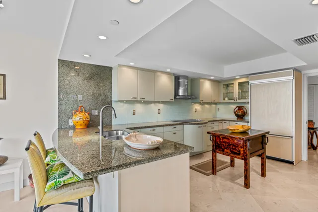 a kitchen with stainless steel appliances granite countertop a sink and a stove