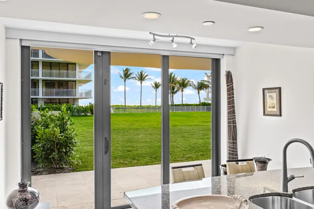 a view of a porch with furniture and a yard