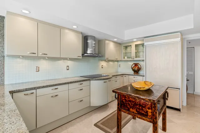 a kitchen with stainless steel appliances granite countertop a sink and a stove