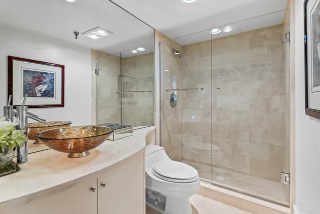 a bathroom with a sink toilet and shower