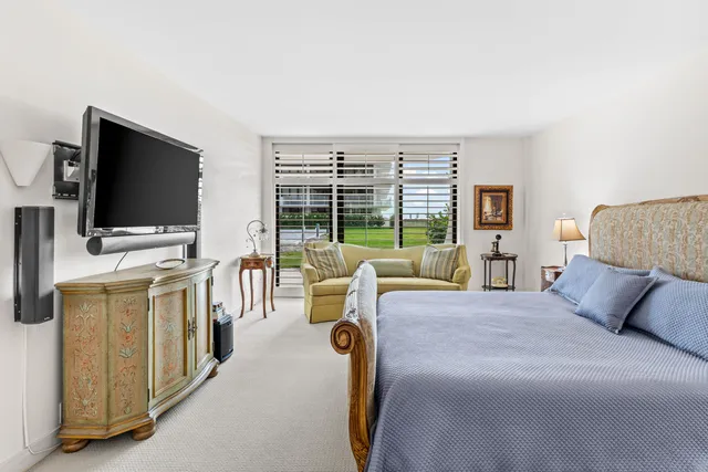 a bedroom with a bed and a television