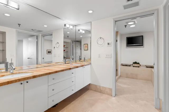 a spacious bathroom with a granite countertop sink mirror and shower