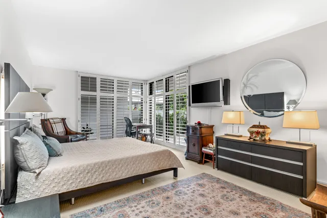 a bedroom with a bed and flat screen tv