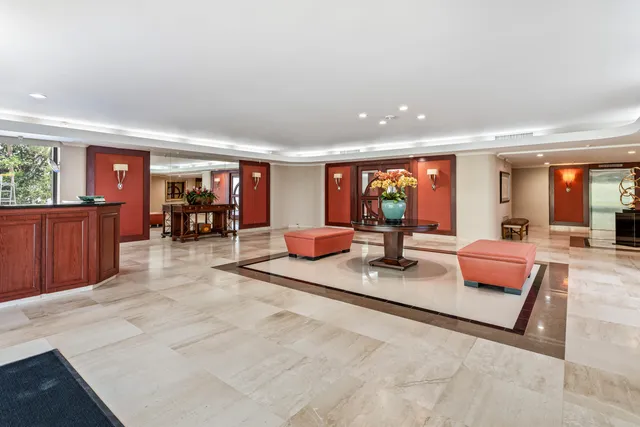 an open kitchen with large windows and couches