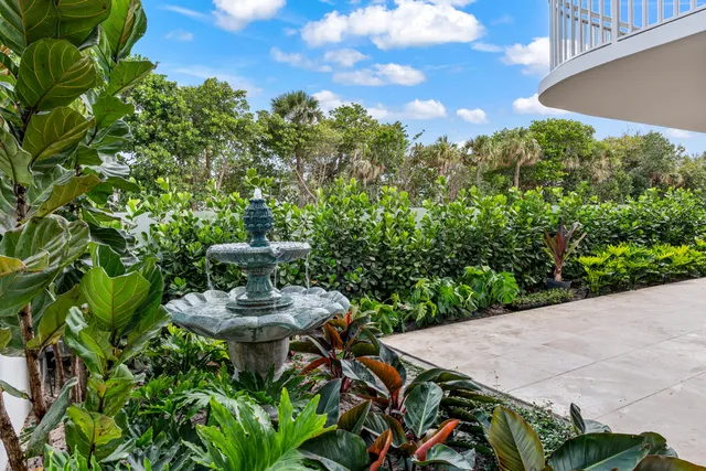 a view of a patio with table and chairs and potted plants