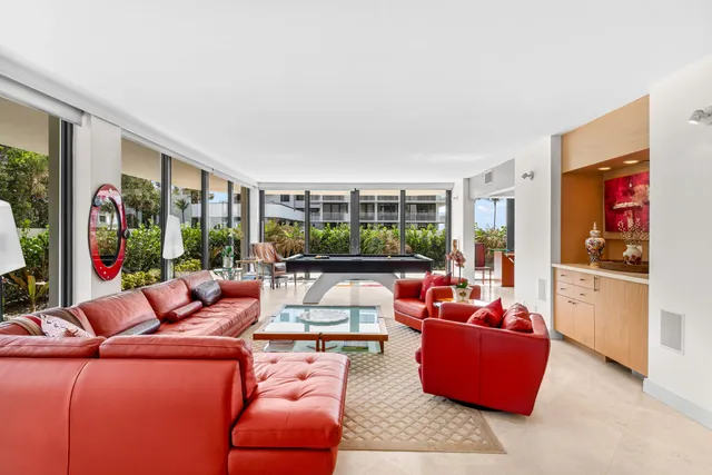 a living room with furniture a couch and a large window