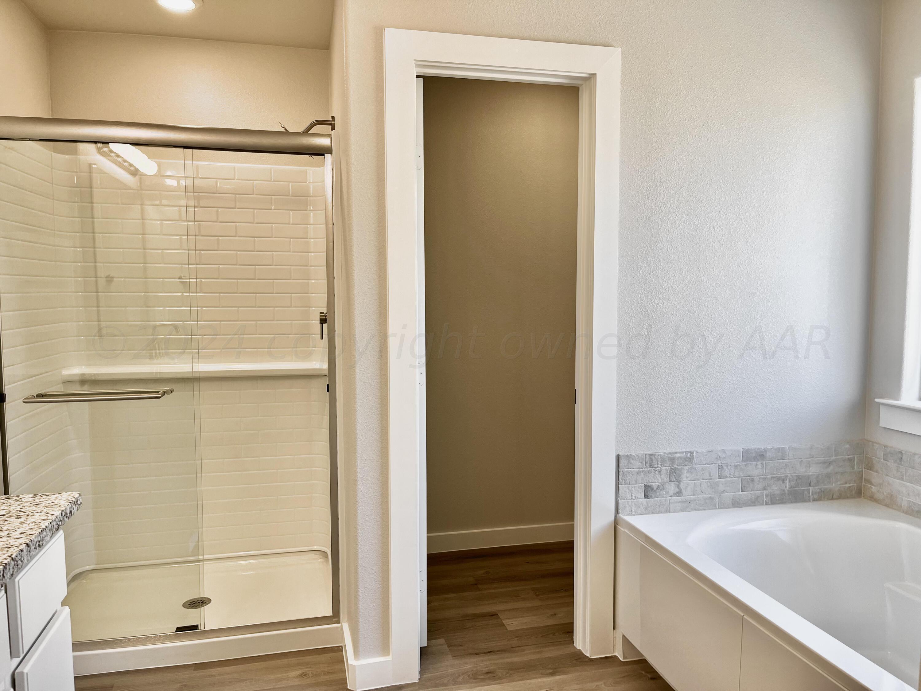 7515 Frazier Road Amarillo, TX 79119 - Photo 14 of 23 a bathroom with a bathtub and a shower