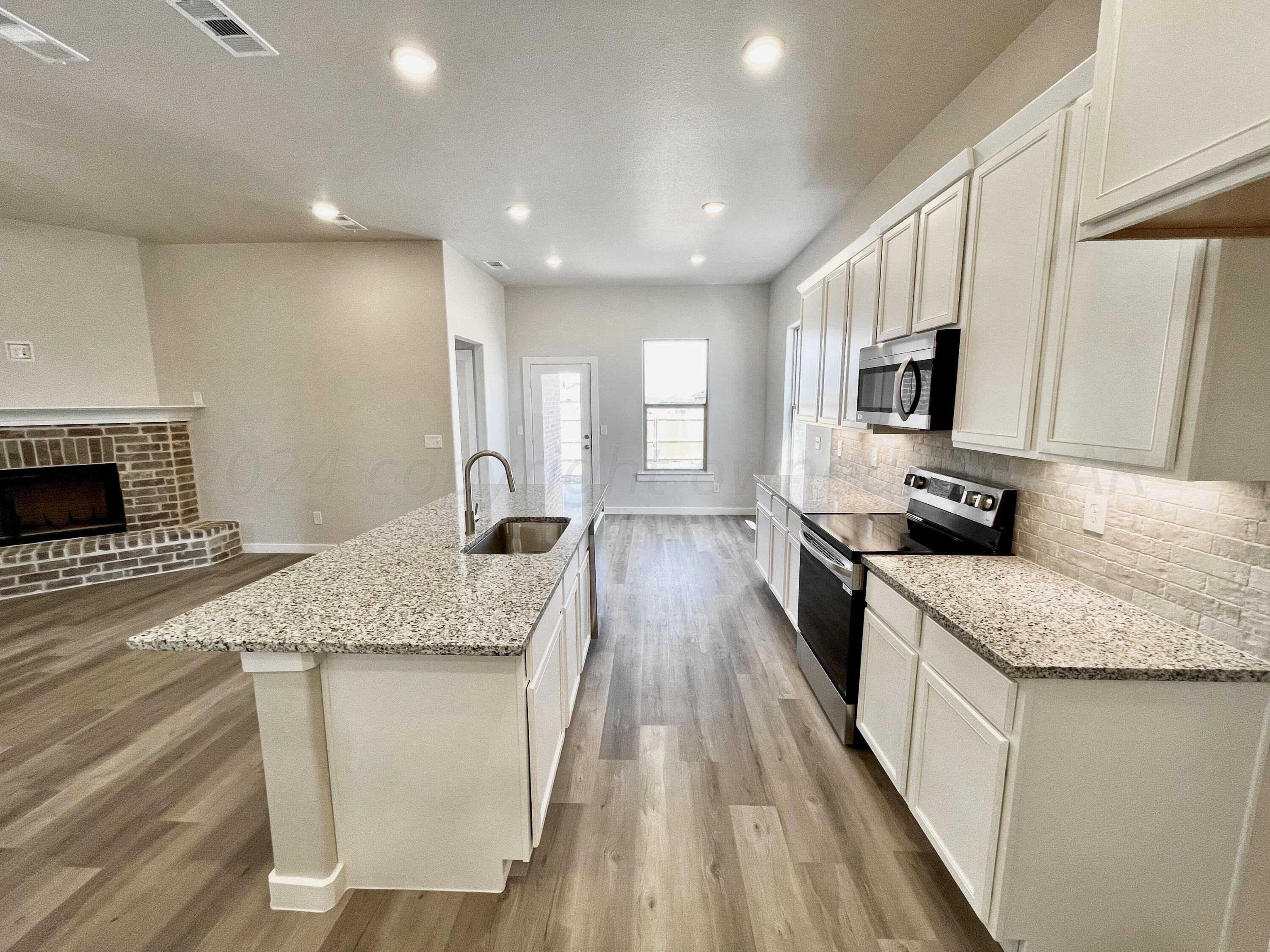 7515 Frazier Road Amarillo, TX 79119 - Photo 21 of 23 a kitchen with stainless steel appliances granite countertop a sink stove and refrigerator