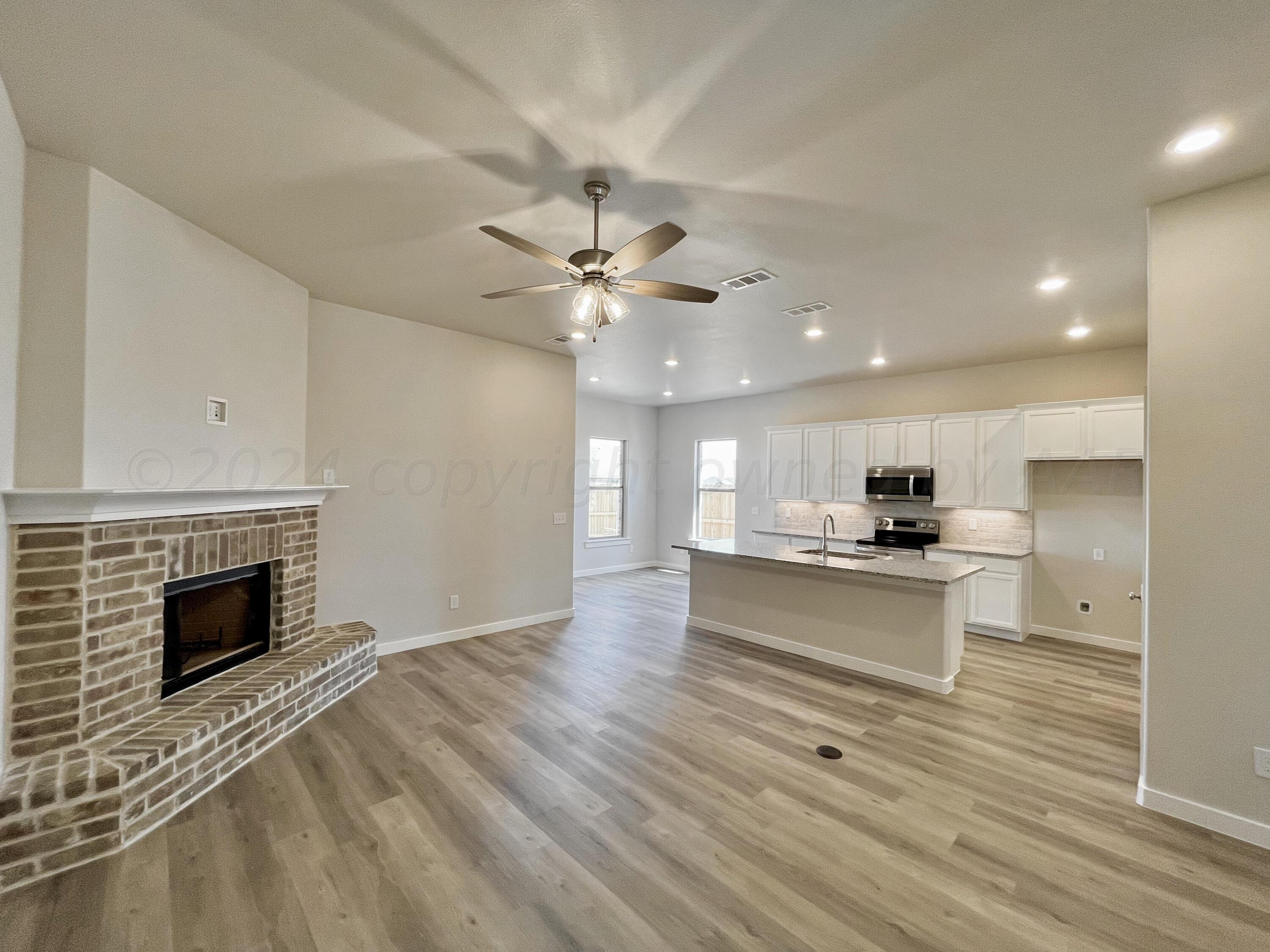 7515 Frazier Road Amarillo, TX 79119 - Photo 22 of 23 a view of kitchen with sink microwave and stove