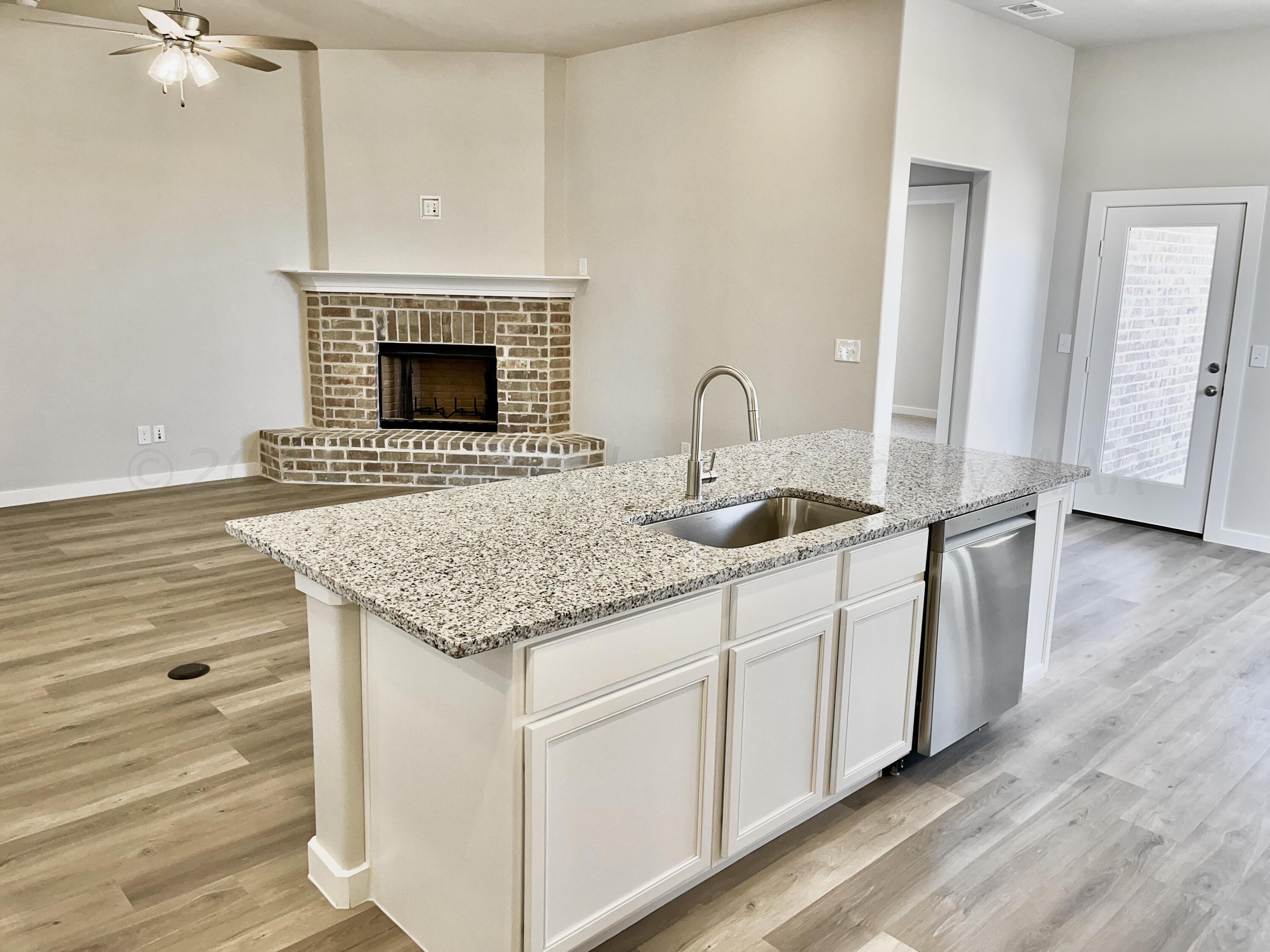 7515 Frazier Road Amarillo, TX 79119 - Photo 7 of 23 a kitchen with granite countertop a sink and a stove