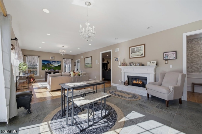 9 Doefield Road Califon, NJ 07830 - Photo 12 of 32 a living room with furniture a fireplace and a chandelier