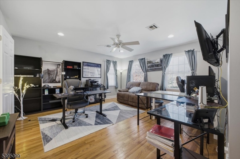 9 Doefield Road Califon, NJ 07830 - Photo 20 of 32 a living room with furniture a rug and a flat screen tv