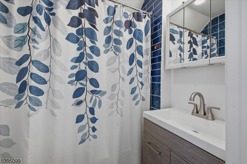9 Doefield Road Califon, NJ 07830 - Photo 28 of 32 a bathroom with a sink and mirror with shower