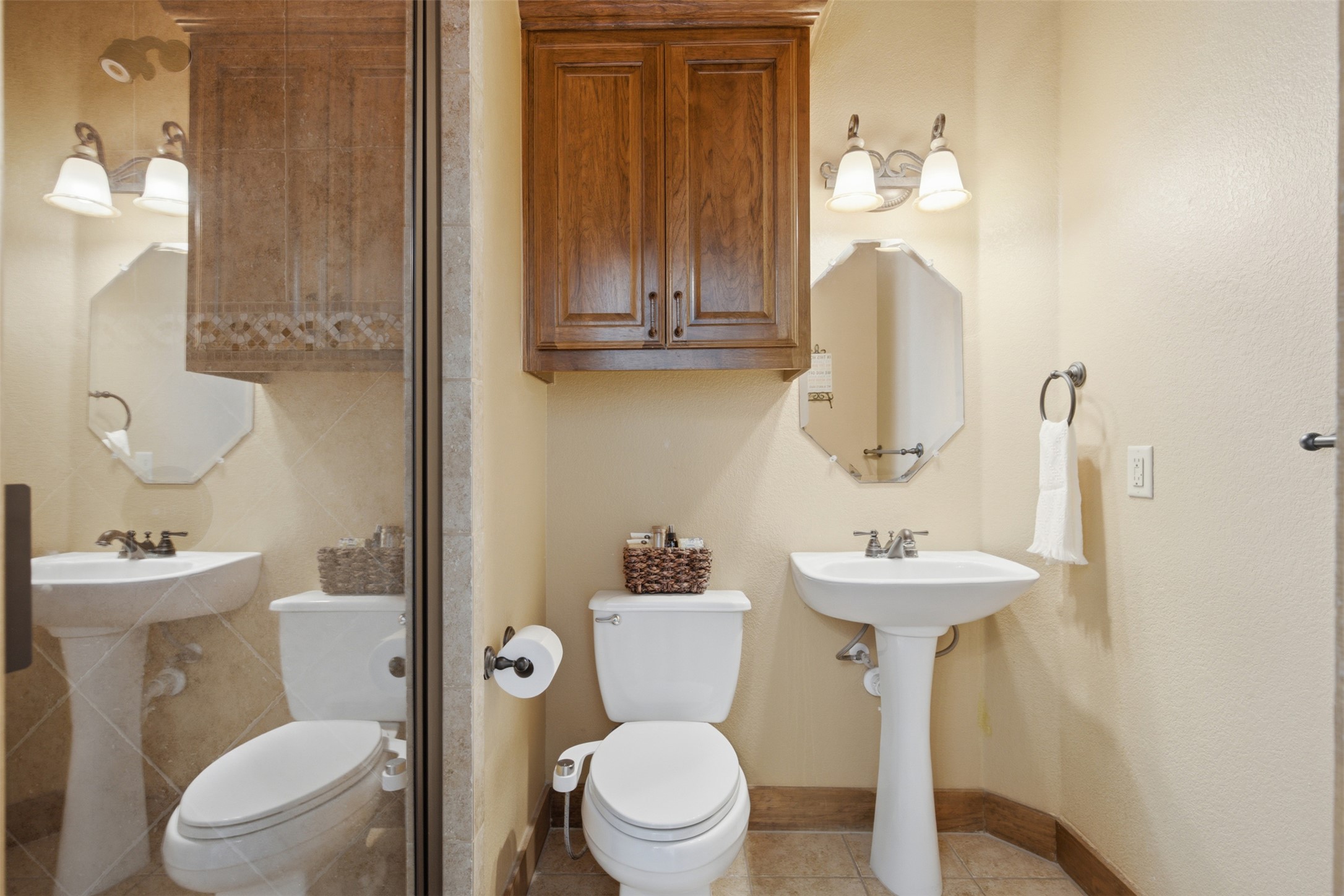 700 Augusta Circle Point Venture, TX 78645 - Photo 18 of 35 A well-appointed bath features dual pedestal sinks and built-in cabinetry for ample storage.