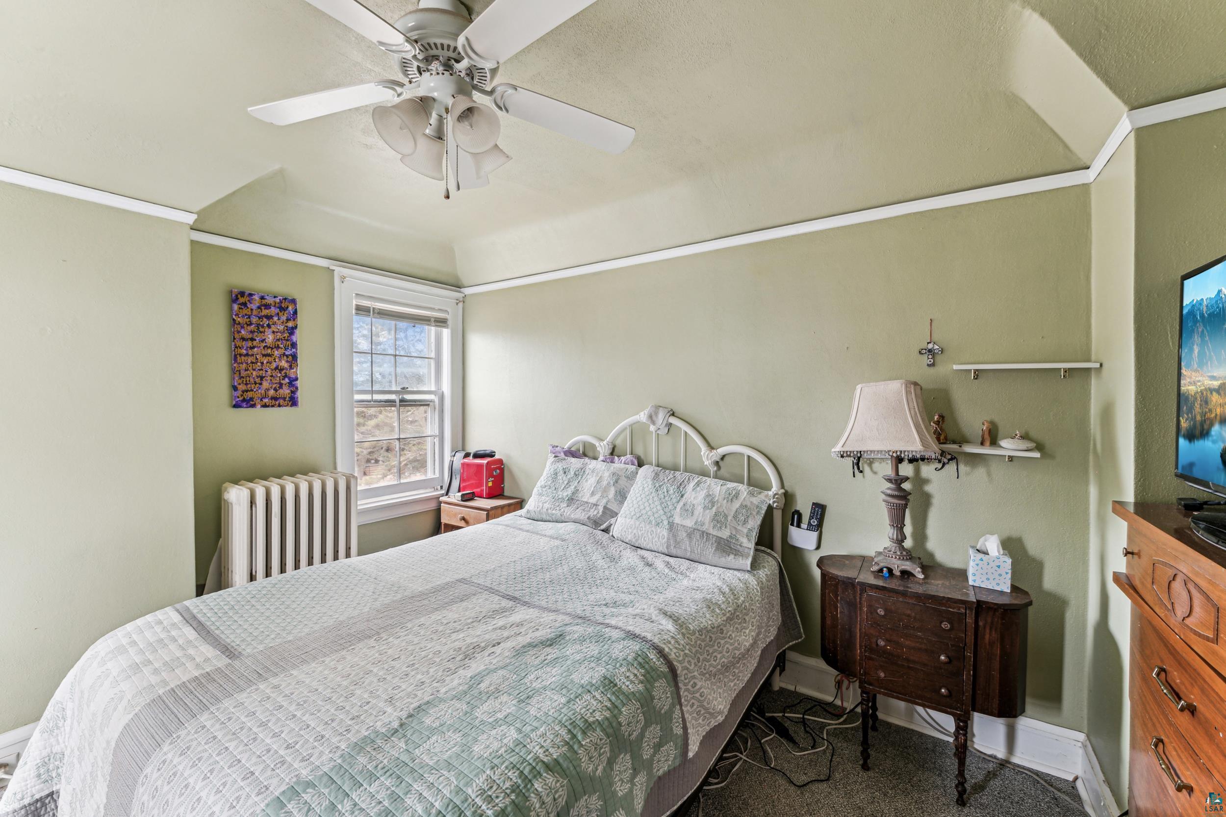 2111 Lakeview Drive Duluth, MN 55803 - Photo 12 of 21 Carpeted bedroom featuring radiator, baseboards, crown molding, and ceiling fan