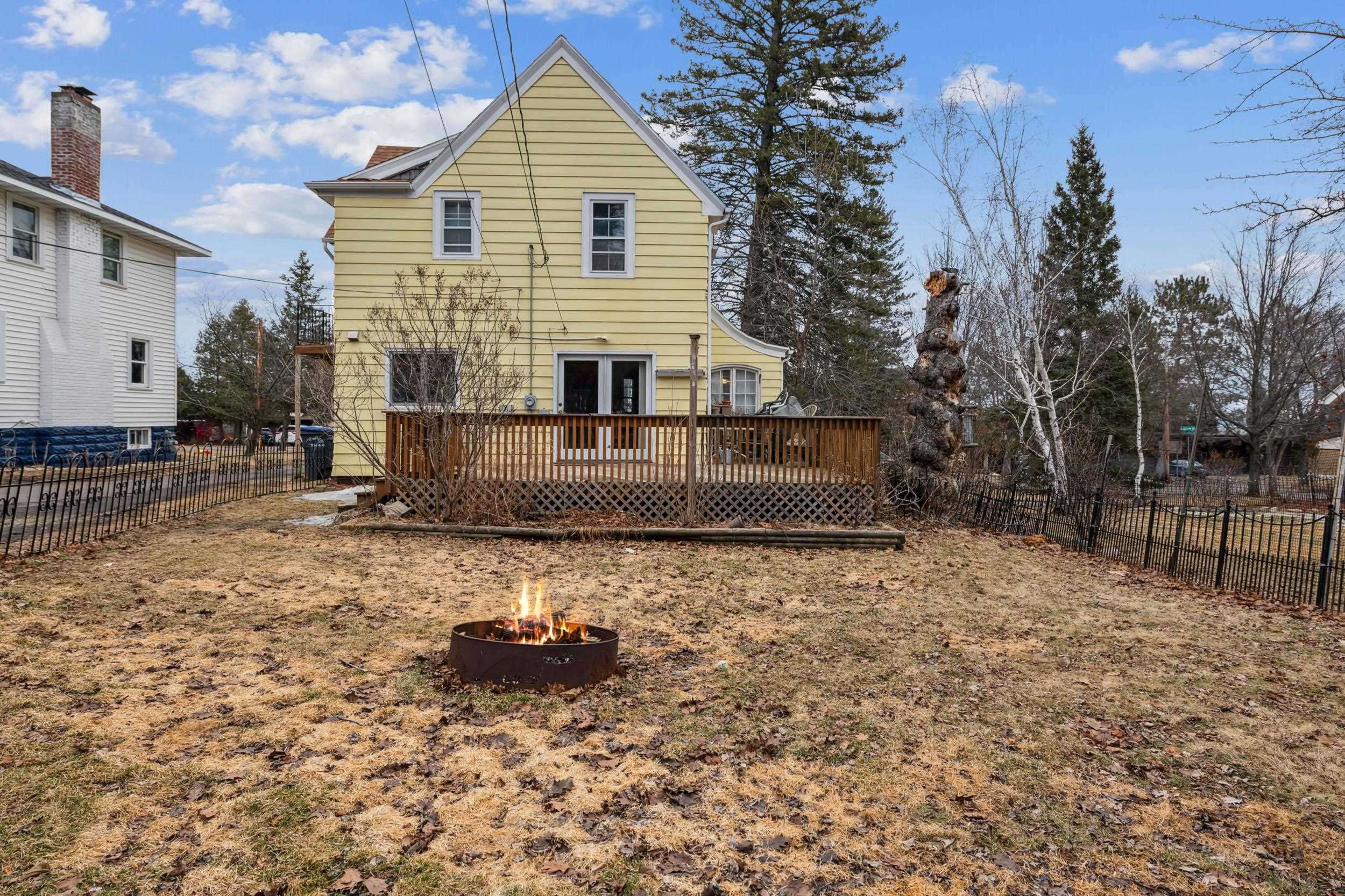 2111 Lakeview Drive Duluth, MN 55803 - Photo 18 of 21 Rear view of house with a fire pit, a fenced backyard, and a wooden deck