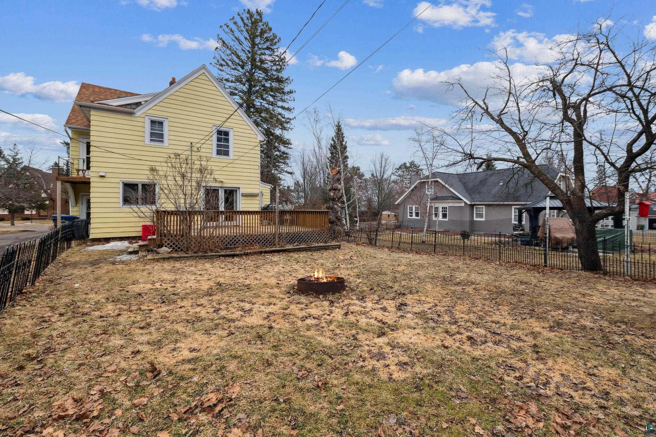 2111 Lakeview Drive Duluth, MN 55803 - Photo 19 of 21 Back of property featuring fence private yard, a fire pit, and a deck