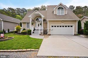 12606 Balte Road Ocean City, MD 21842 - Photo 2 of 51 a front view of a house with a yard