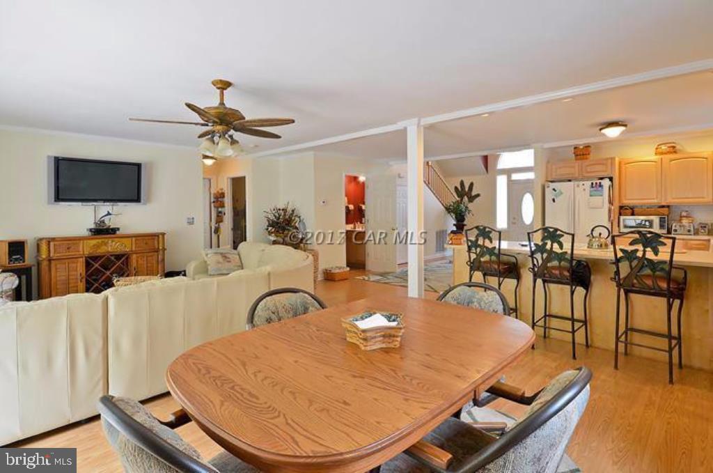 12606 Balte Road Ocean City, MD 21842 - Photo 11 of 51 a living room with furniture a flat screen tv and kitchen view