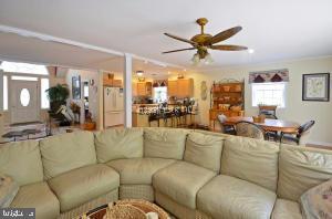 12606 Balte Road Ocean City, MD 21842 - Photo 20 of 51 a living room with furniture a ceiling fan and a large window