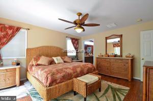 12606 Balte Road Ocean City, MD 21842 - Photo 22 of 51 a bedroom with a bed and wooden floor