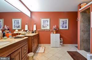 12606 Balte Road Ocean City, MD 21842 - Photo 25 of 51 a spacious bathroom with a sink and a mirror