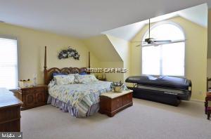 12606 Balte Road Ocean City, MD 21842 - Photo 29 of 51 a spacious bedroom with a bed couch and a window