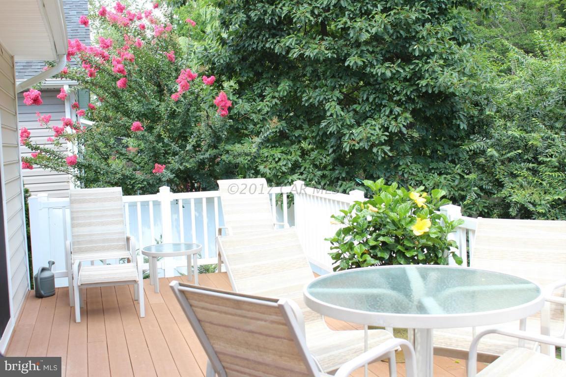 12606 Balte Road Ocean City, MD 21842 - Photo 40 of 51 a backyard of a house with table and chairs