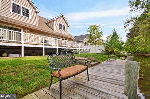 12606 Balte Road Ocean City, MD 21842 - Photo 5 of 51 a view of a deck with a table and chairs