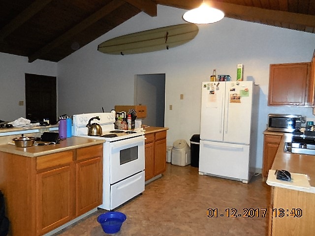 441 Copp Road Kula, HI 96790 - Photo 11 of 21 a kitchen with a refrigerator stove and white cabinets