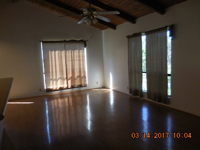 441 Copp Road Kula, HI 96790 - Photo 5 of 21 a view of an empty room with wooden floor and a window