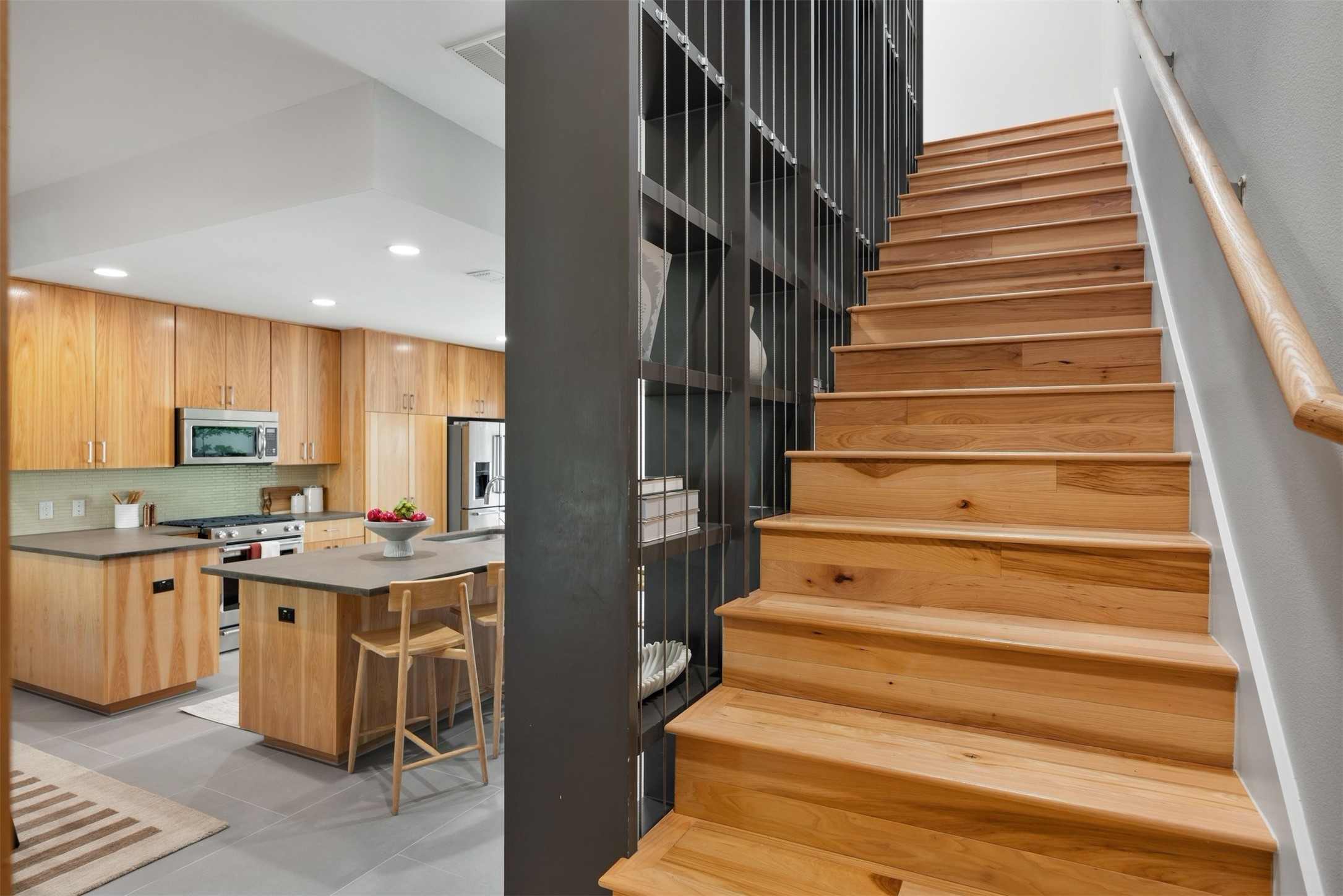 3921 Threadgill Street Austin, TX 78723 - Photo 20 of 36 Custom built-in shelving runs alongside the open staircase, giving you a place to display books, photos, and favorite art pieces